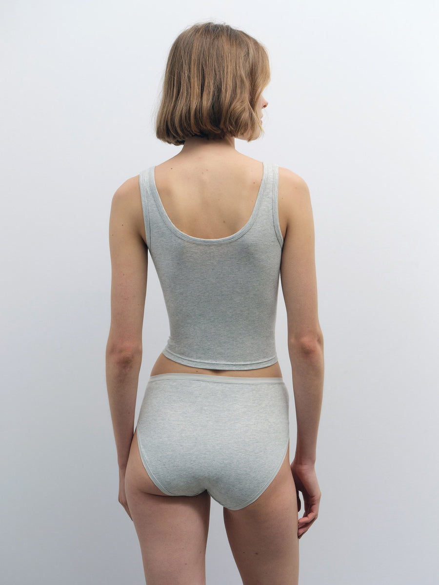 Woman from behind wearing a light grey organic cotton crop tank and matching high-cut briefs.