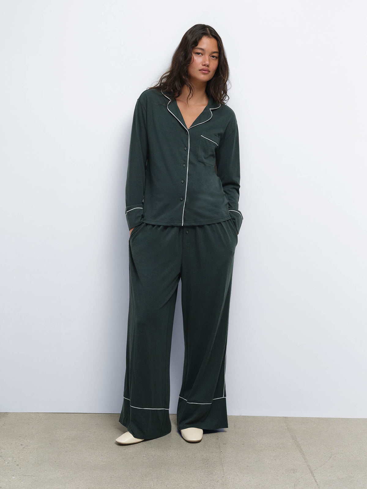 Full-length view of model with hands in pockets wearing the Tencel Sleep Set in Balsam with Heather Grey