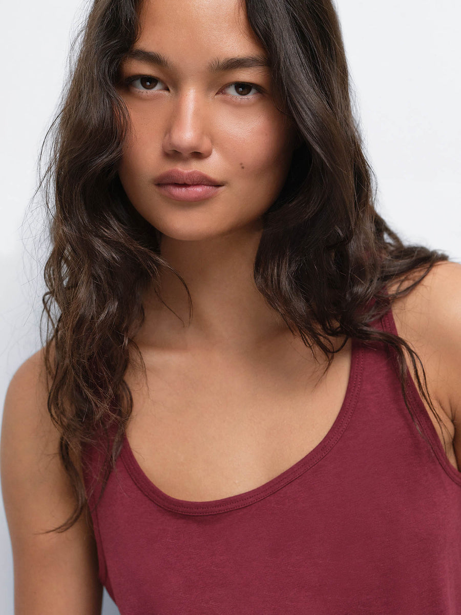 Close-up portrait of model wearing the Tencel Sleep Scoop Tank in Garnet