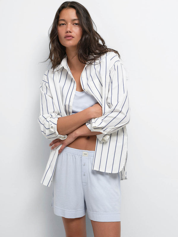 Model wearing a striped button-up shirt over the Tencel Sleep Scoop Tank and Boxer Short in Powder