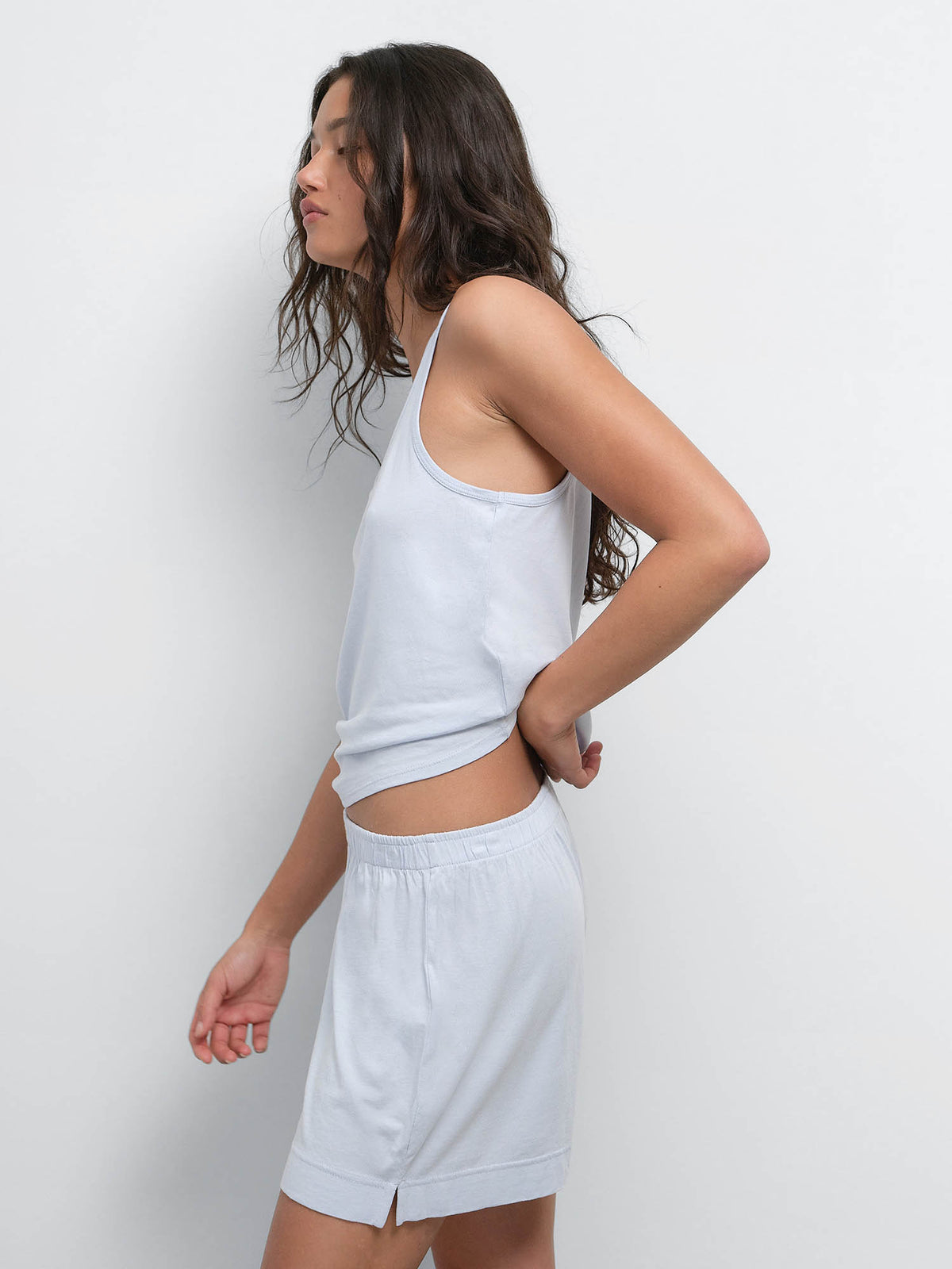 Side view of model wearing the Tencel Sleep Scoop Tank and Boxer Short in Powder