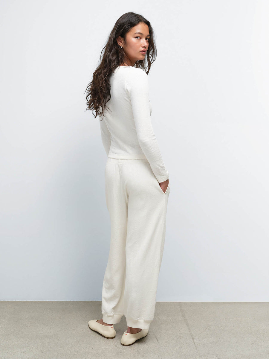 Side view of model wearing the Organic Pointelle Henley and Jogger in Cream