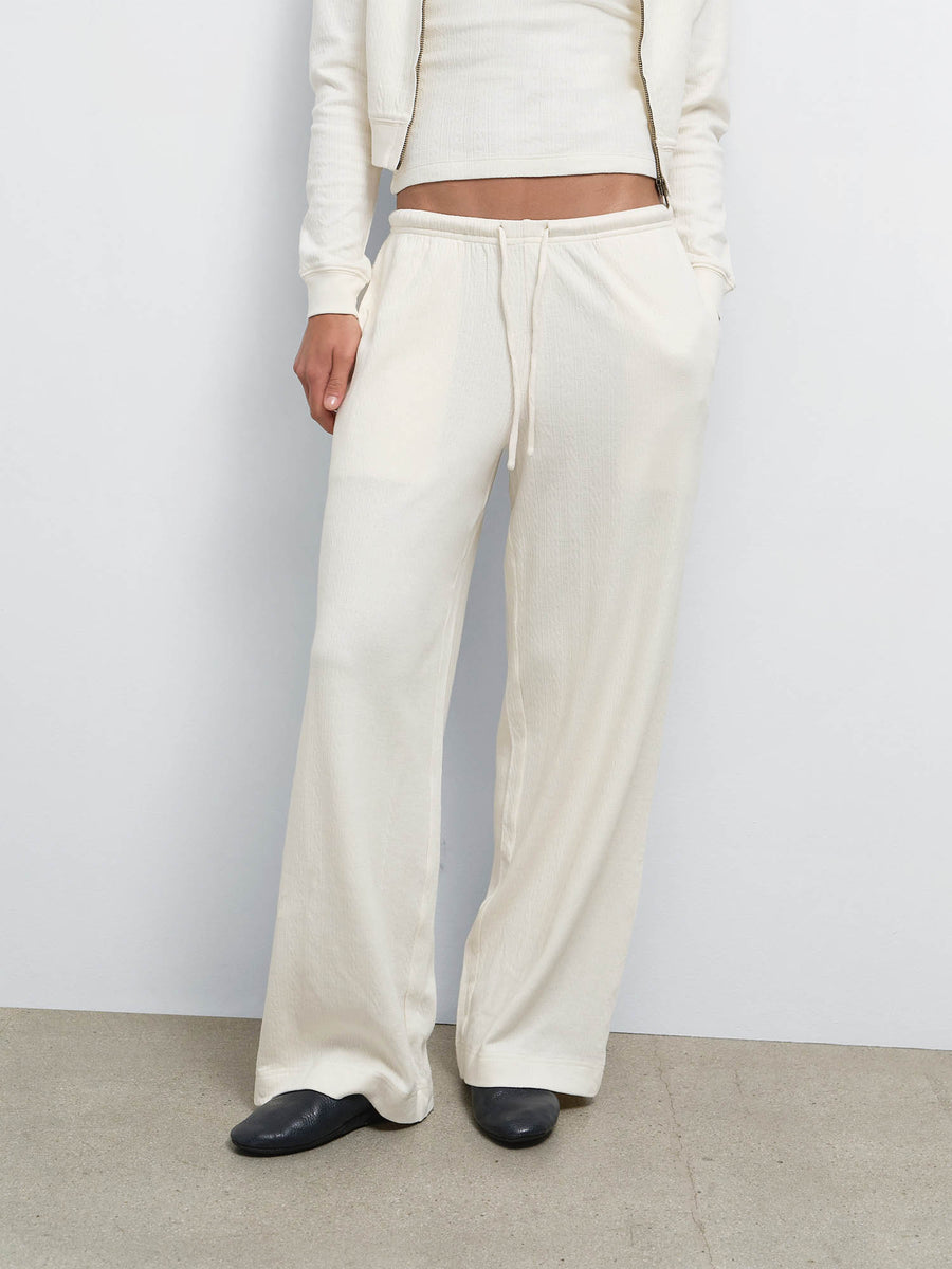 Close-up of the wide-leg Organic Pointelle Pant in Cream worn with black flats