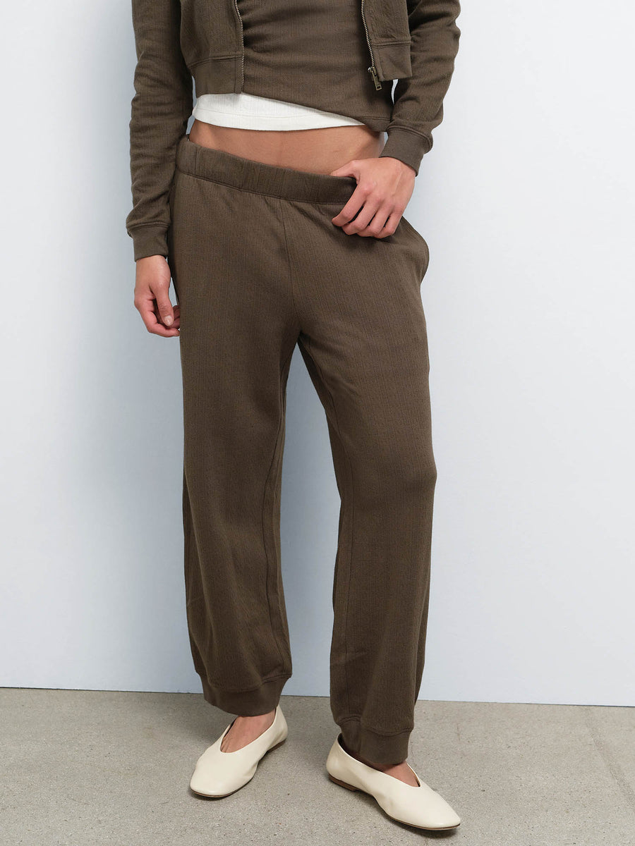 Close-up of model in the Organic Pointelle Jogger in Mocha with the matching hoodie and cream ballet flats