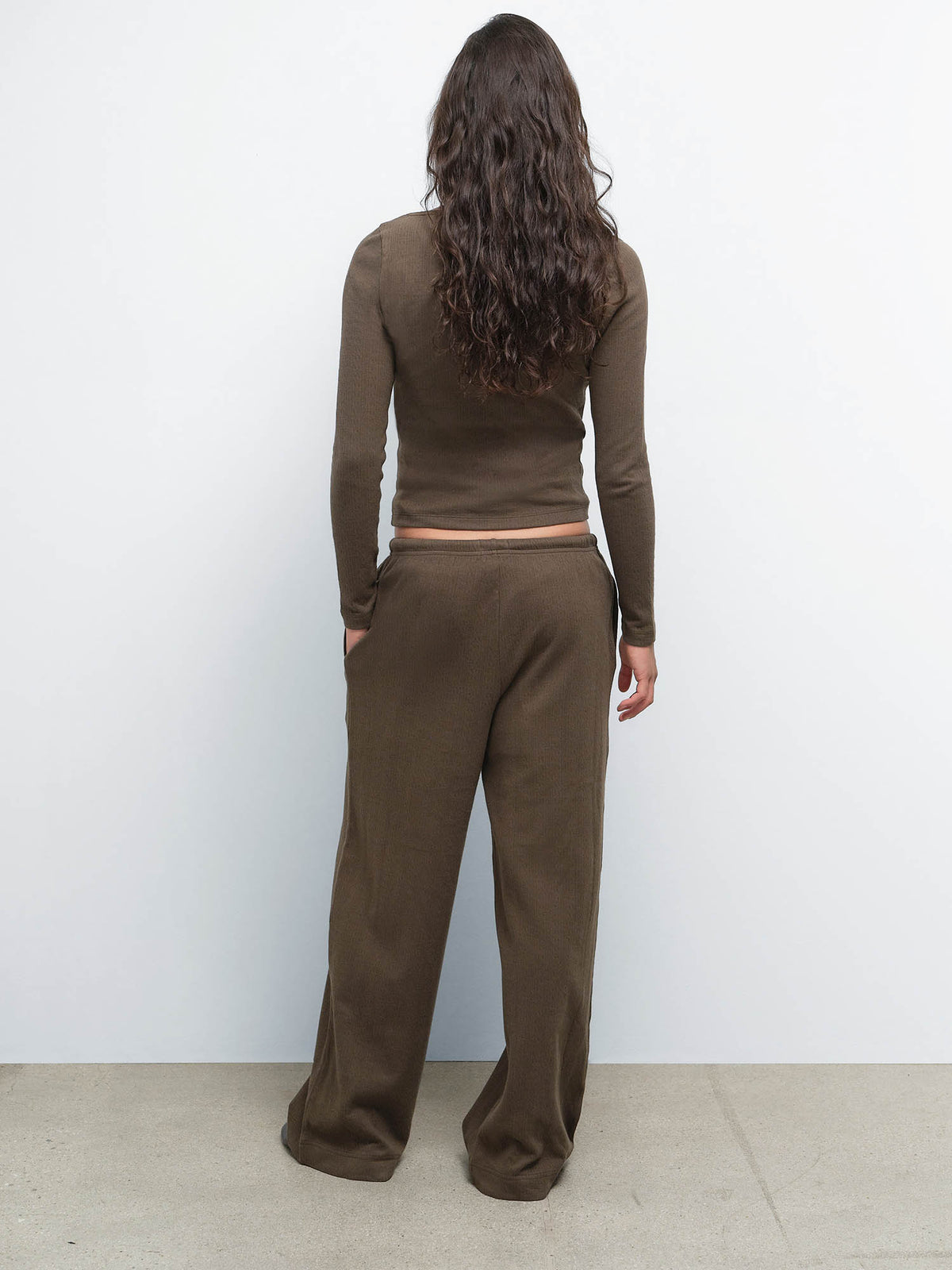 Back view of model wearing the Organic Pointelle Henley and Pant in Mocha