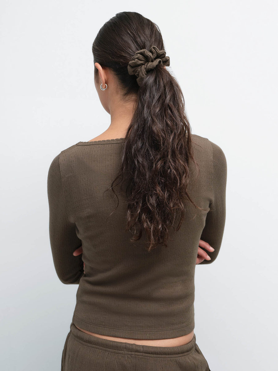 Back view of model with a twisted ponytail wearing the Organic Pointelle Henley in Mocha