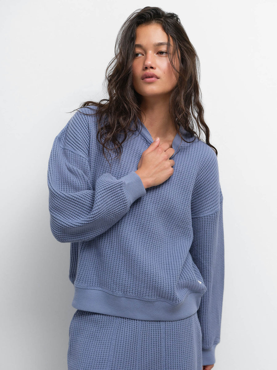 Close-up of model with hand on chest wearing the Organic Waffle Crewneck Sweatshirt in Bay