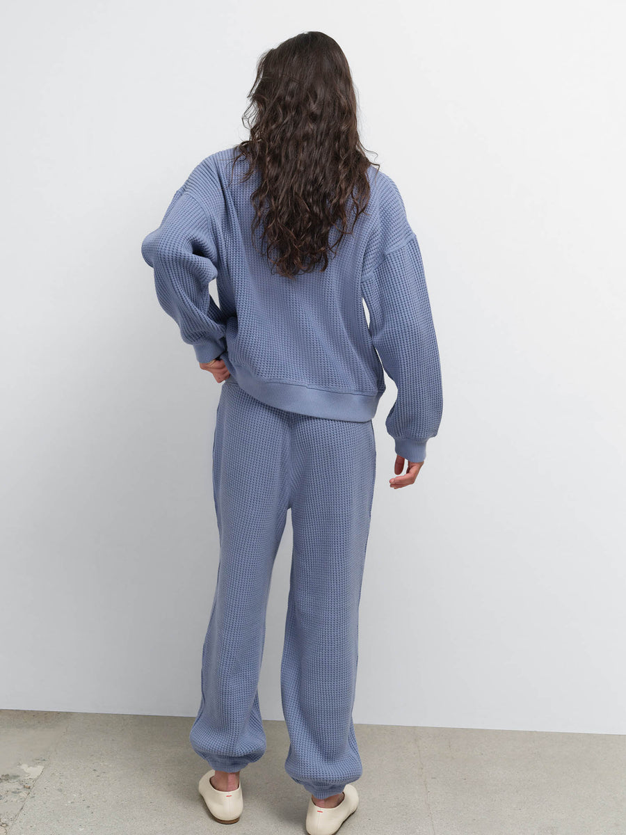 Back view of model in the Organic Waffle Crewneck Sweatshirt and Sweatpant in Bay with cream flats