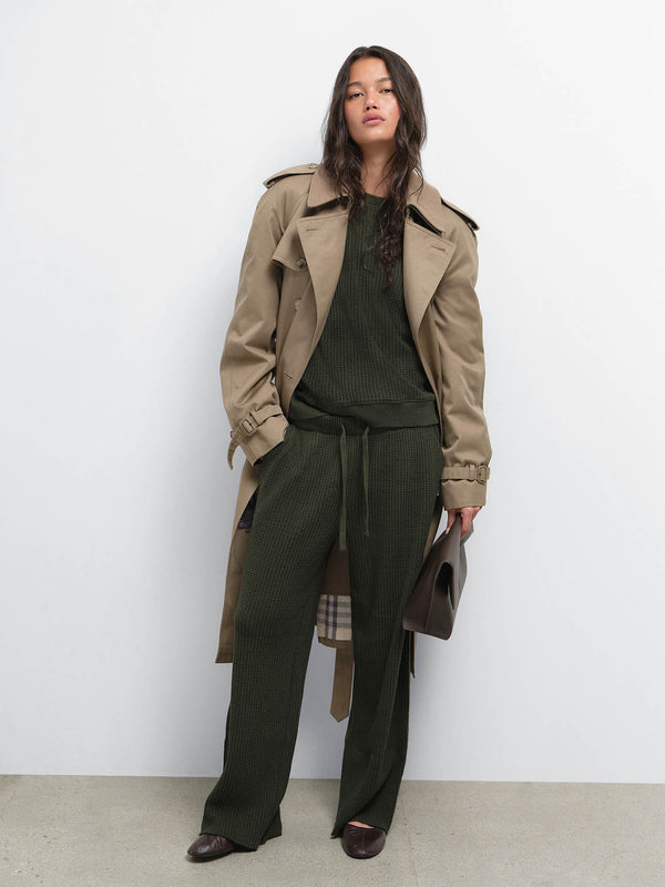Model in a tan trench coat over the Organic Waffle Crewneck Sweatshirt and Straight Leg Sweatpant in Heather Pine
