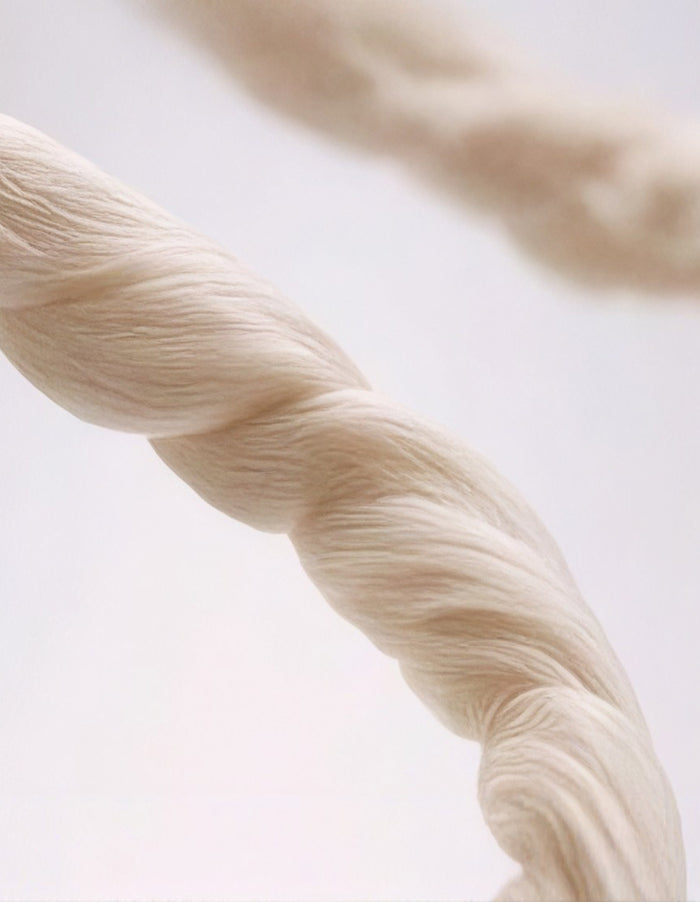 Close-up editorial image illustrating the natural fibers and considered materials used by MATE.