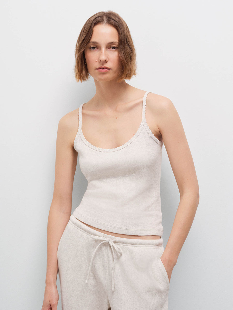 Woman wearing an oatmeal ribbed camisole and matching wide-leg pants, front view in studio