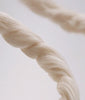 Close-up video of twisted beige cotton fabric fibers